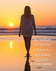 Footsteps in sand at sunrise, symbolizing a woman’s healing journey beginning with her first step.